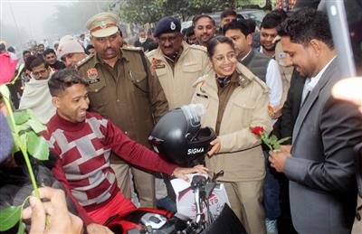 SP Upasna distributed helmets to create awareness about traffic rules.